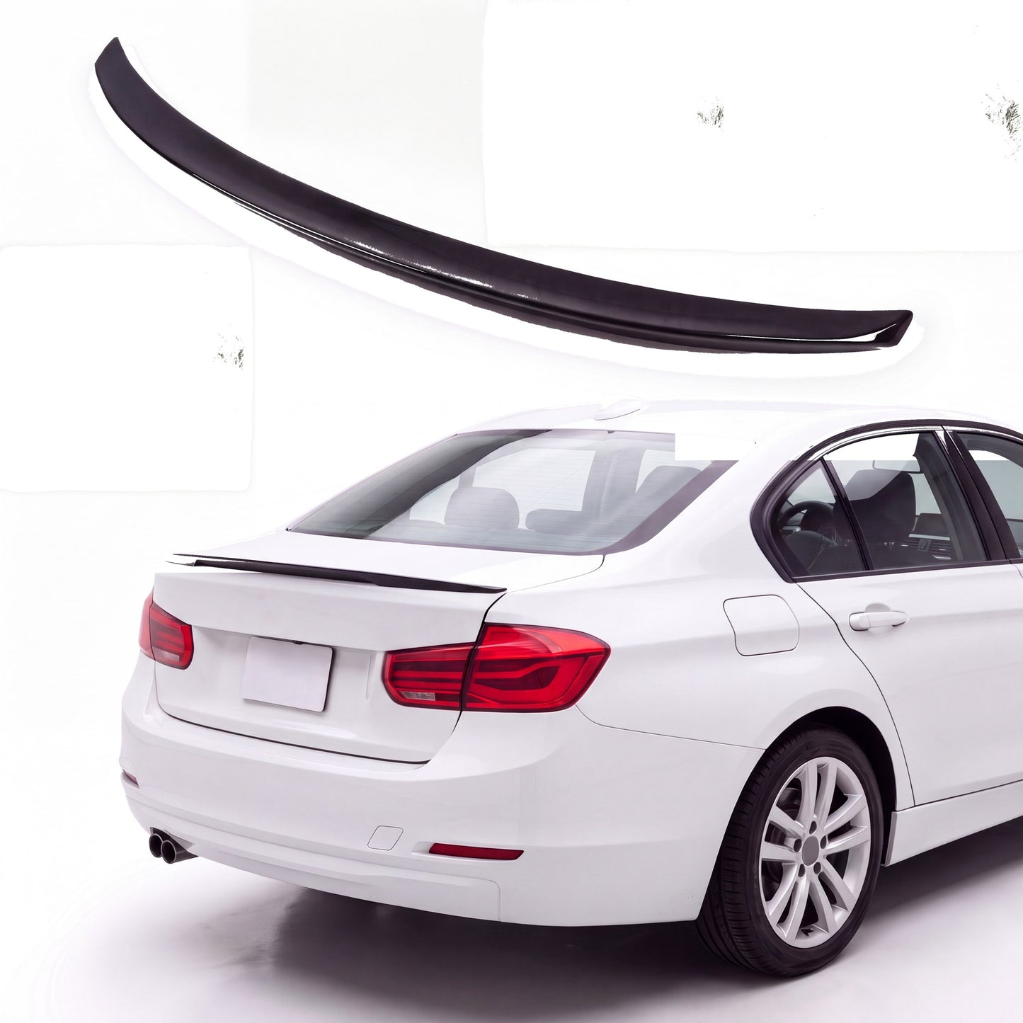 Gloss black trunk lip spoiler on white BMW 3 Series F30 sedan rear three-quarter view