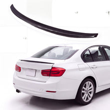 Gloss black trunk lip spoiler on white BMW 3 Series F30 sedan rear three-quarter view