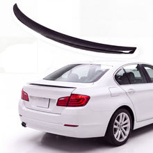 Gloss black trunk lip spoiler on white BMW 5 Series F10 sedan rear three-quarter view