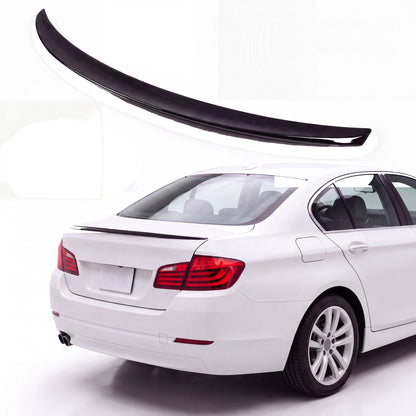 Gloss black trunk lip spoiler on white BMW 5 Series F10 sedan rear three-quarter view