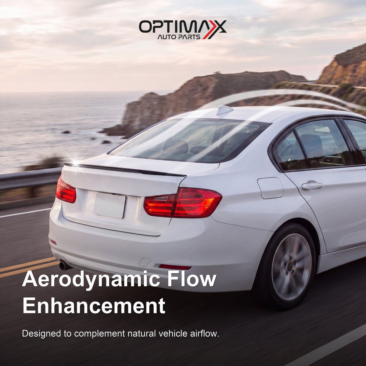 Gloss black trunk lip spoiler on white BMW 3 Series F30 sedan aerodynamic flow enhancement on coastal road