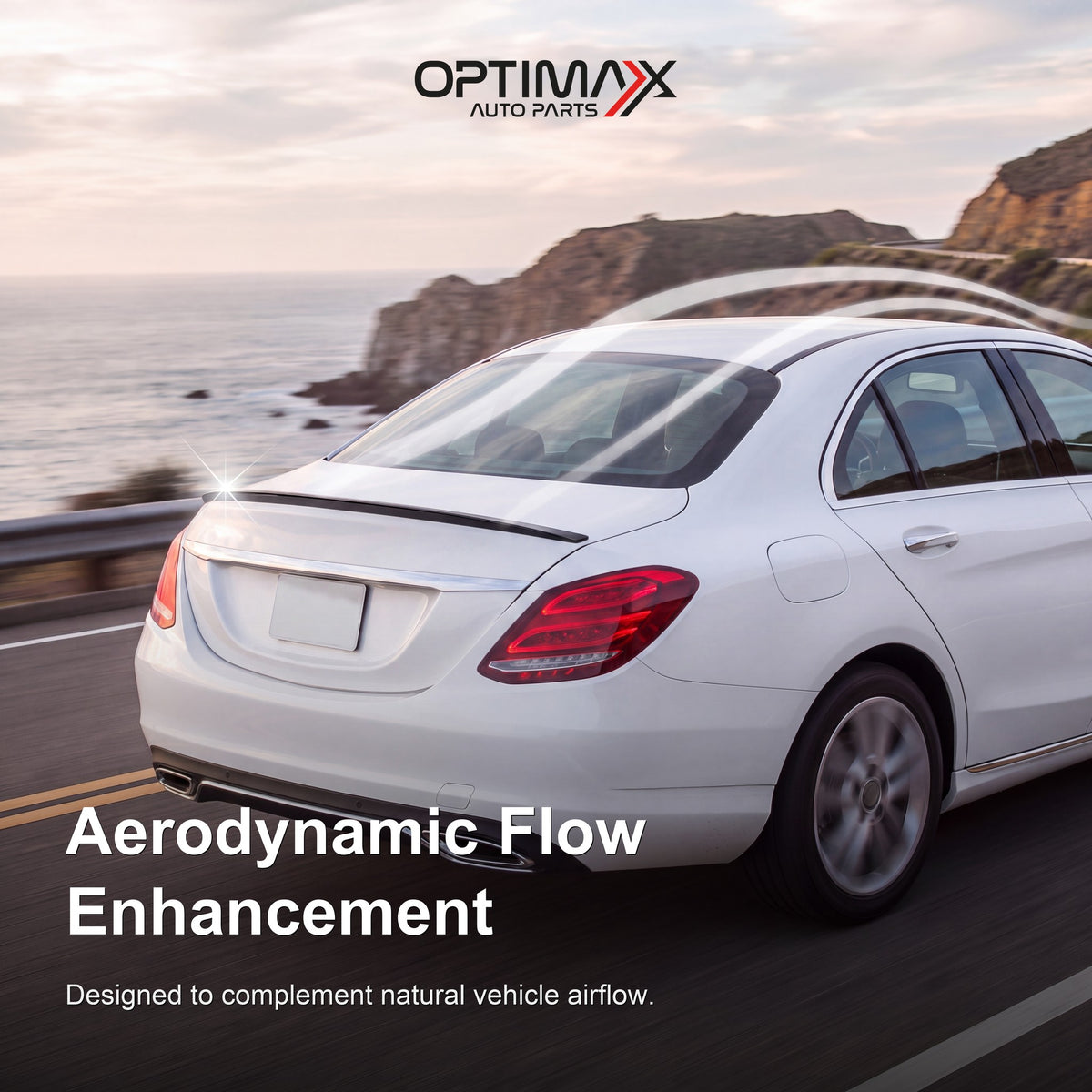 Gloss black trunk lip spoiler on white Mercedes-Benz C-Class W205 sedan aerodynamic flow enhancement on coastal road