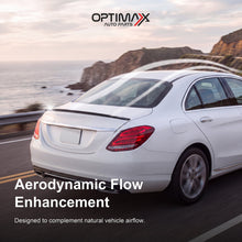 Gloss black trunk lip spoiler on white Mercedes-Benz C-Class W205 sedan aerodynamic flow enhancement on coastal road