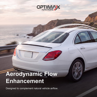 Gloss black trunk lip spoiler on white Mercedes-Benz C-Class W205 sedan aerodynamic flow enhancement on coastal road